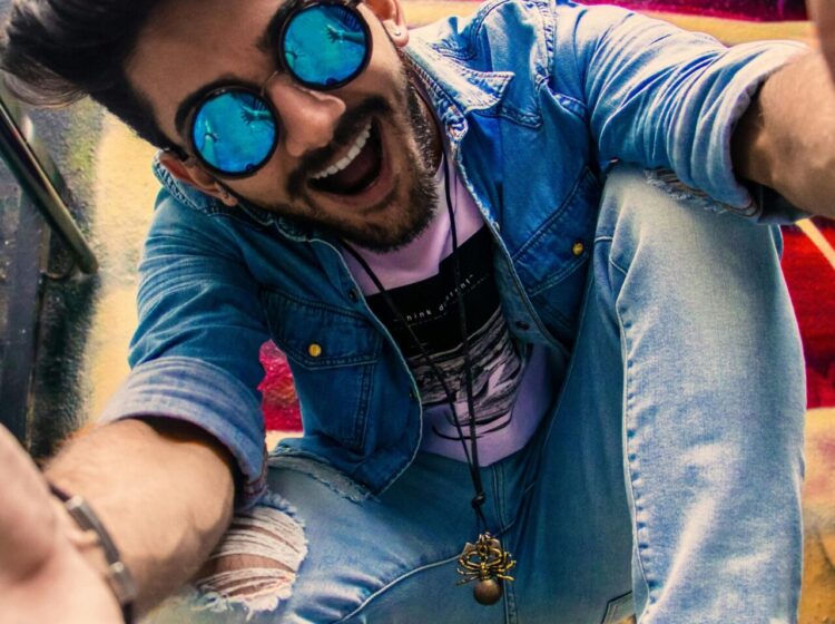 A lively portrait of a young man in urban streetwear, enjoying a vibrant city background.