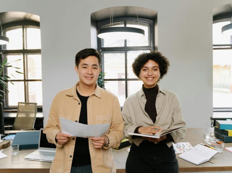 Smiling colleagues planning business strategy in a modern office environment.